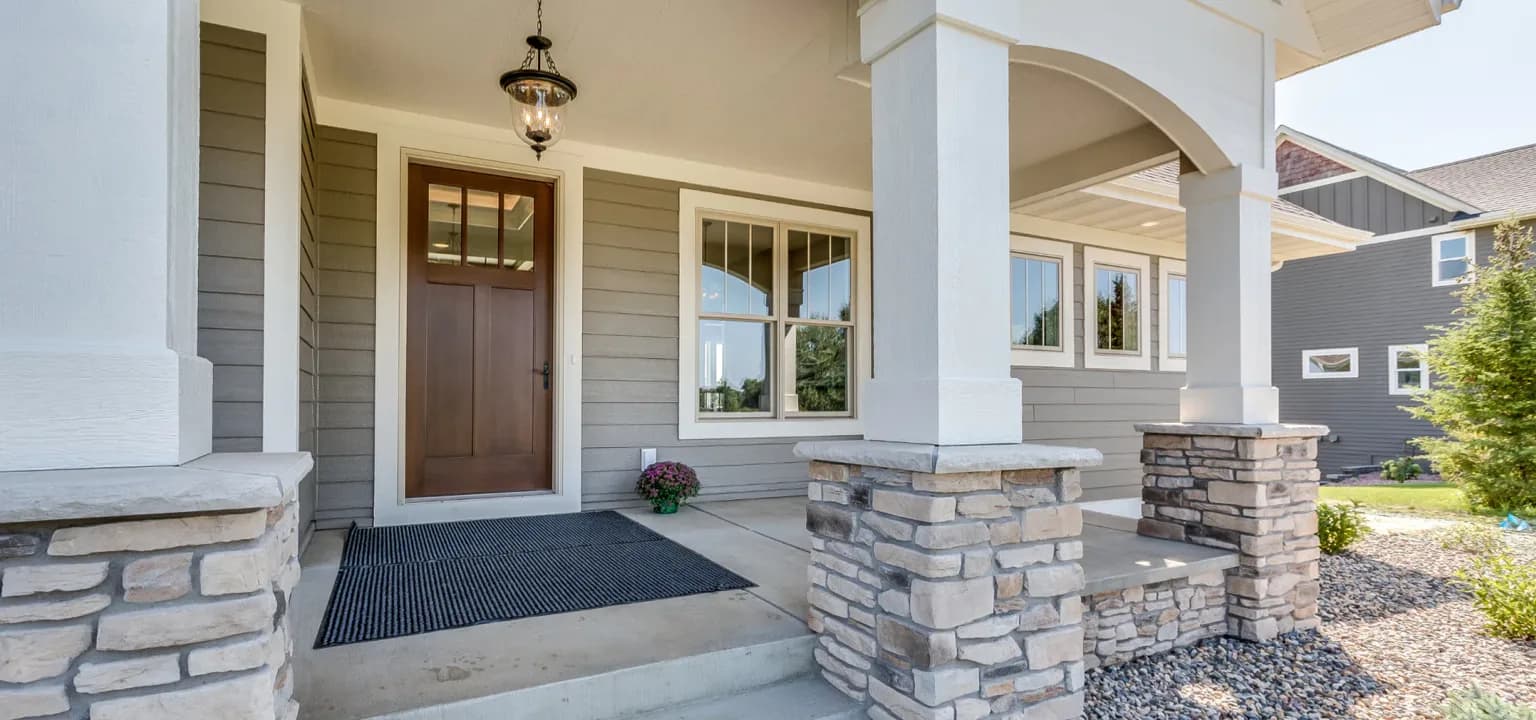 Covered front porch with new entry door and windows