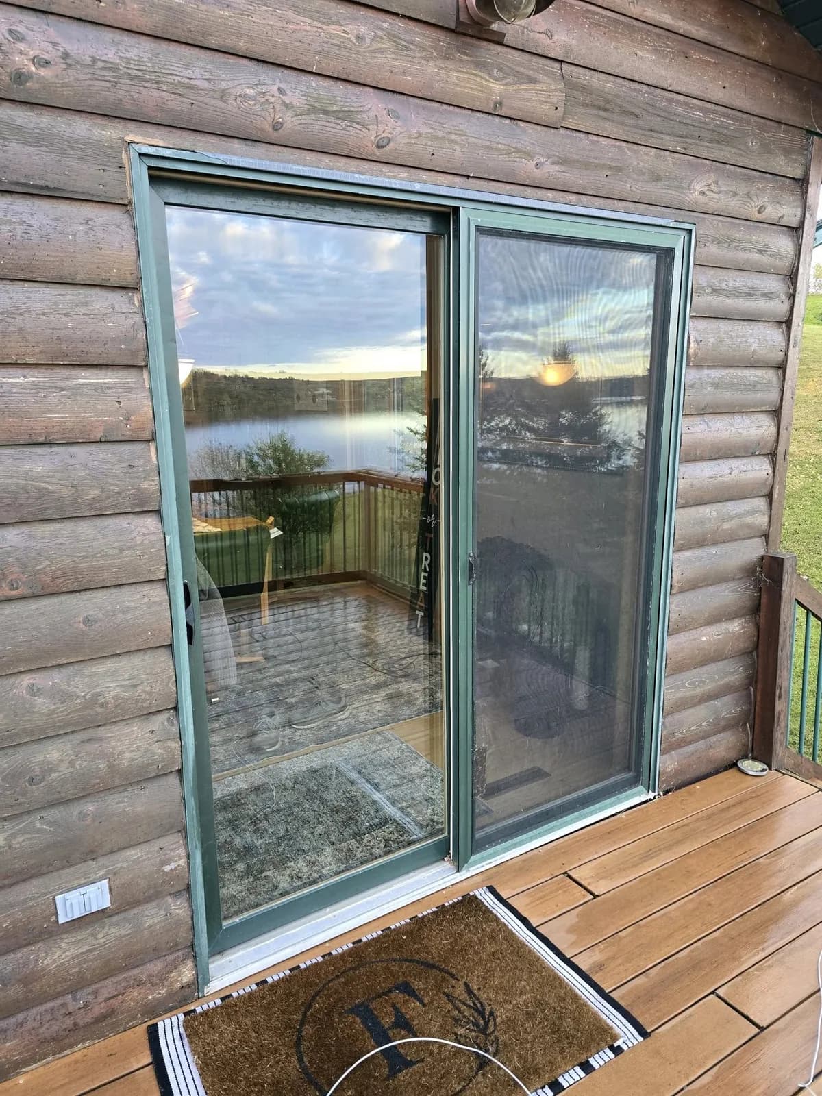 Sliding patio door on a log-sided lake home